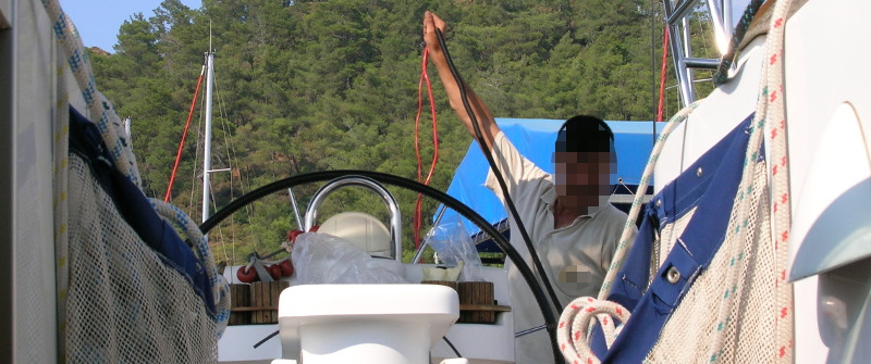 Technician pulling wire aboard a yacht photo elenameg.com