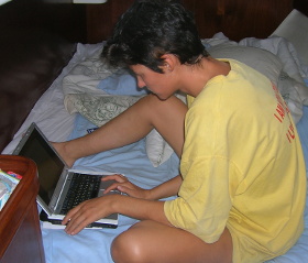 Elena Vaytsel with laptop computer in her yacht cabin photo elenameg.com